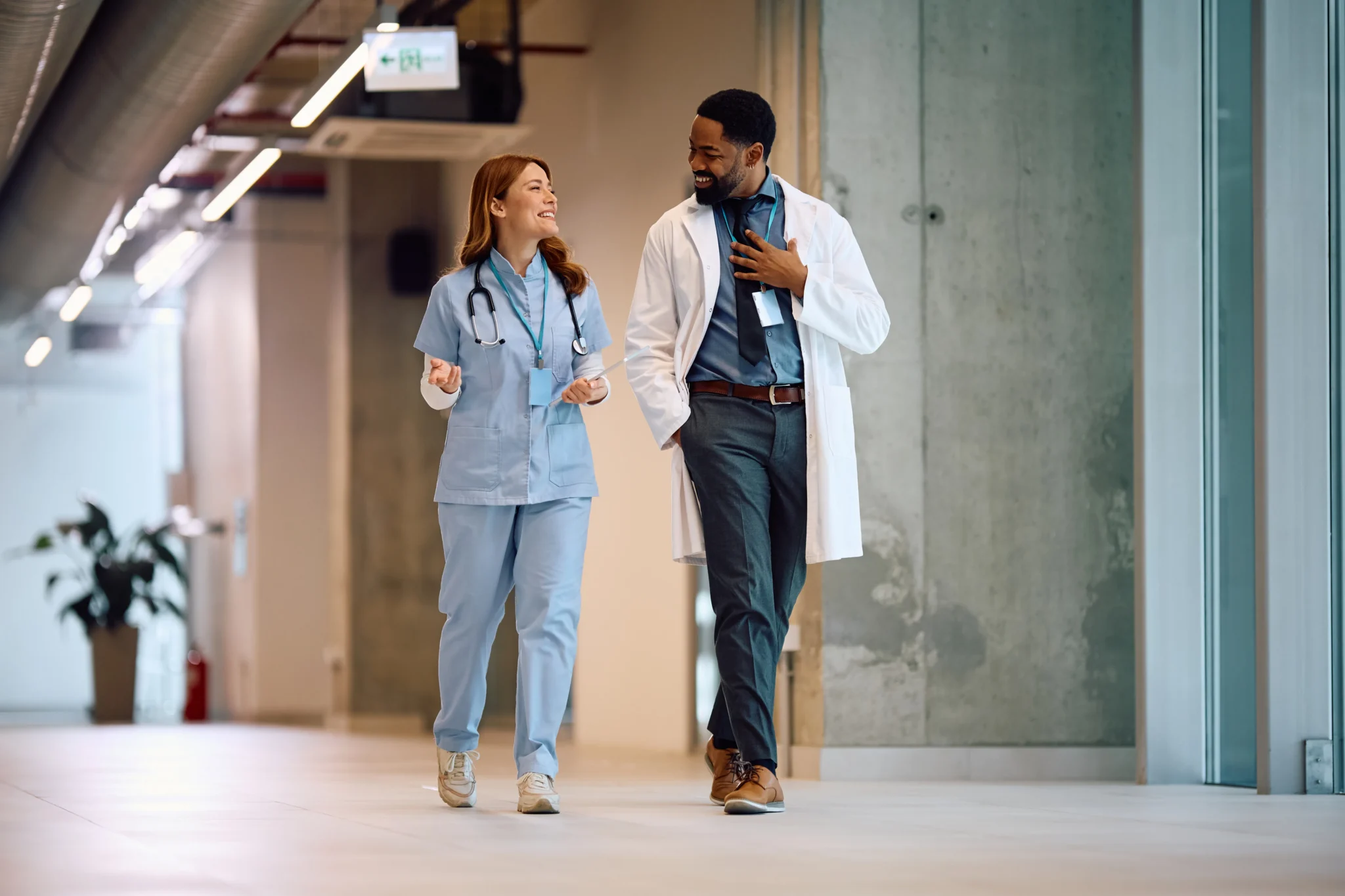 Healthcare professionals walking together in a clinic hallway