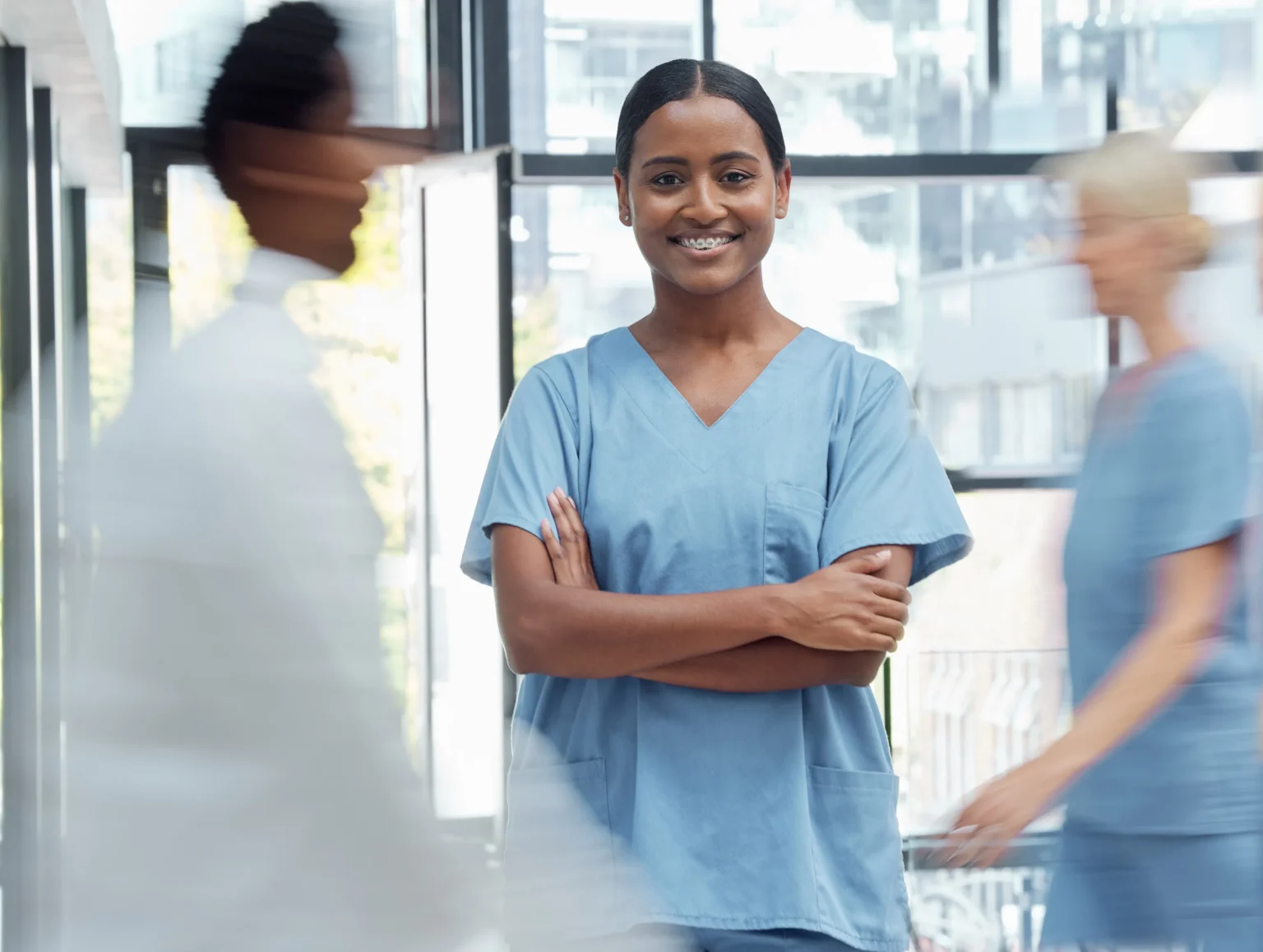 Confident healthcare professional in a hospital corridor