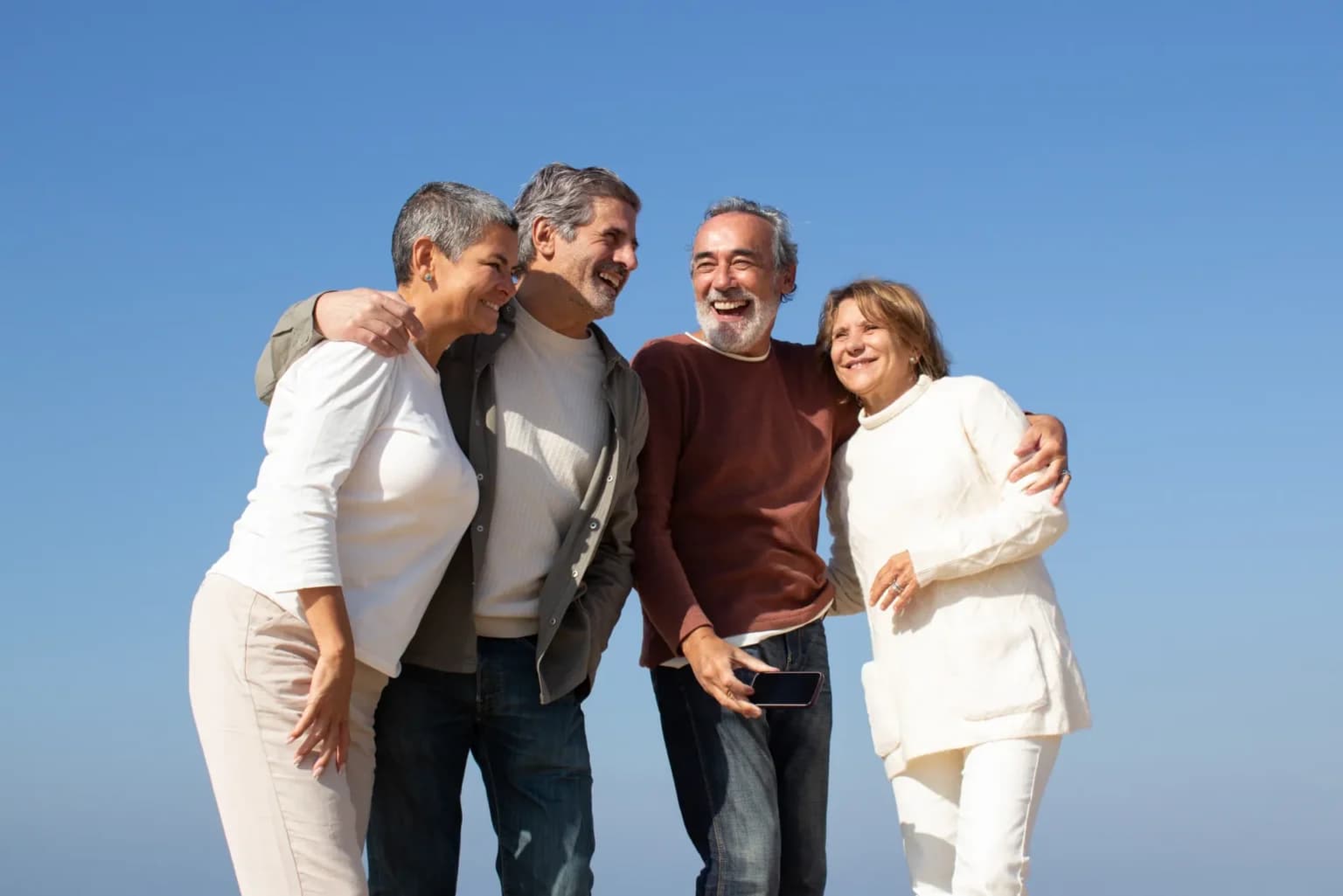 Senior couples laughing together outdoors